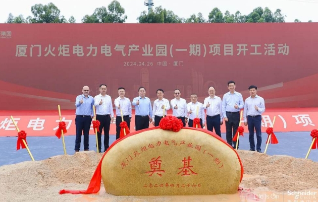 A group of men standing in front of a large rockDescription automatically generated